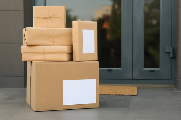 Cardboard boxes near door. Parcel delivery service - Fotó, kép