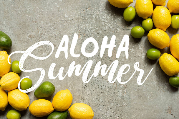 top view of colorful avocado, limes and lemons on grey concrete surface, aloha summer illustration - 写真・画像