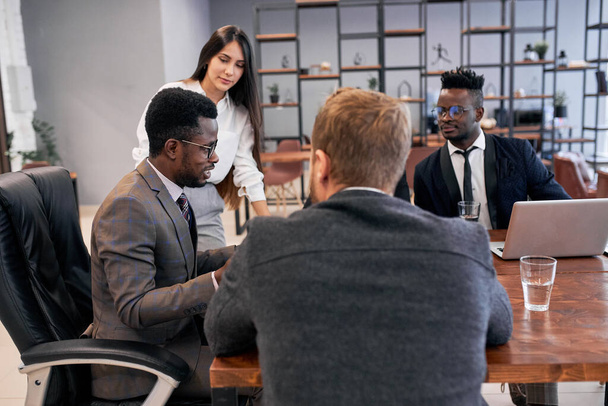 Multi-ethnic team of businesspeople meeting in modern office - Фото, зображення