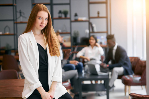 Portrait of cute young business lady smiling and look at camera in an office environment - Photo, Image