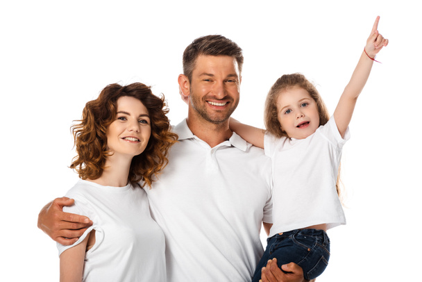 happy father holding in arms cute daughter pointing with finger near curly wife isolated on white - Photo, Image