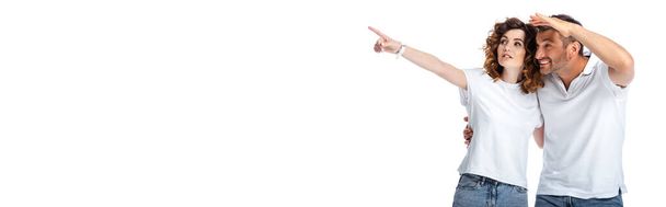 website header of curly woman pointing with finger near cheerful husband looking away isolated on white  - Photo, Image