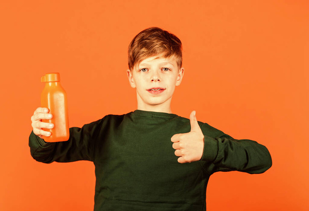 Smoothie detox cocktail. Refreshing beverage concept. Water balance. Small child drink juice orange background. Little boy enjoy drinking fruit juice. Juice healthy part of kids diet. Juice recipe - Fotó, kép