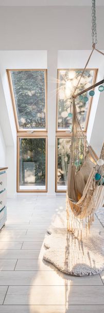 Vertical panorama of modern attic room with window and stylish hammock seat - Фото, зображення