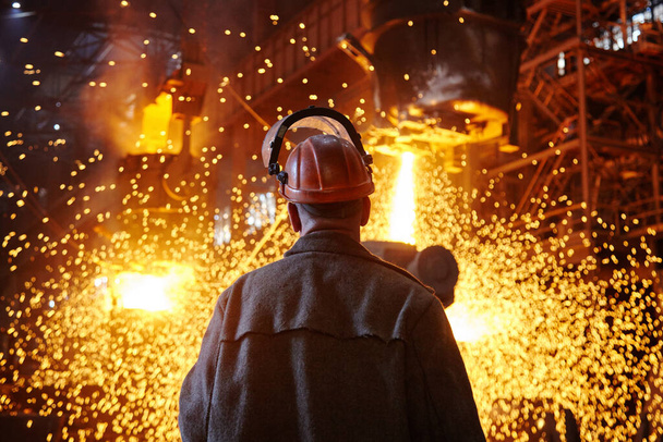 Steelmaker at ingot casting. Electric arc furnace shop EAF. Metallurgy. - Photo, Image