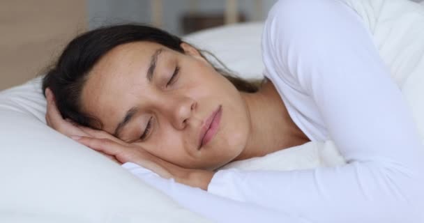 Calm healthy young woman serene face sleeping well in bed - Metraje, vídeo