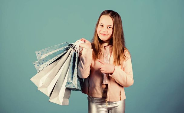 Shopping day happiness. Buy clothes. Fashionista addicted buyer. Fashion boutique. Birthday girl shopping. Fashion trend. Fashion shop. Little girl with bunch packages. Happy child in shop with bags - Fotografie, Obrázek