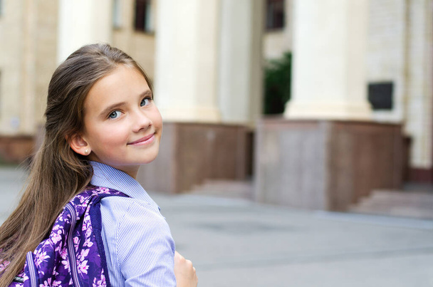 Back to school. Education concept. Cute smiling schoolgirl on the way to the school. Happy little girl child with backpack - Foto, Bild