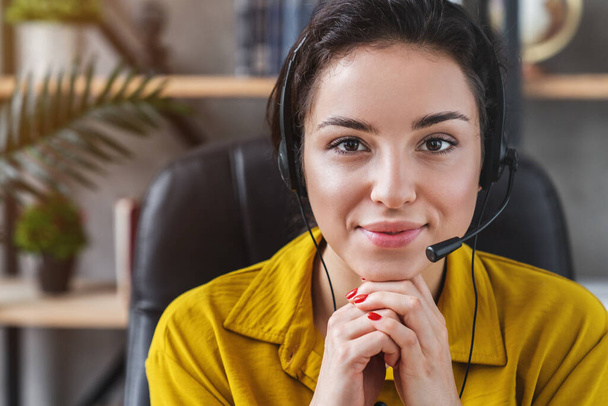 Friendly woman customer support, consultant or call service operator looking at camera - Zdjęcie, obraz
