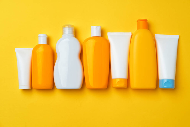 Collection of sunscreen cream bottles on yellow background - Photo, Image