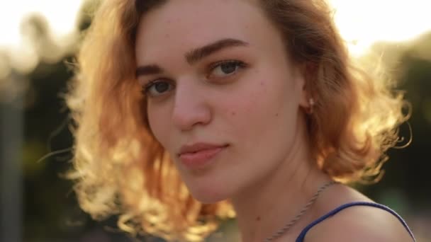 Pretty attractive woman model gazing at camera in the summer park - Materiaali, video