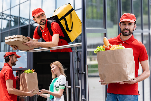 Collage of smiling courier holding pizza boxes and giving shopping bag with grocery to woman on urban street  - Valokuva, kuva