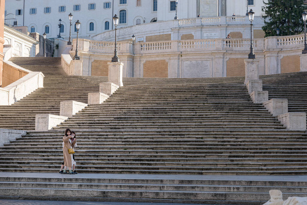 Rome, Italy - 10 March 2020: Two female tourists take a selfie in front of the empty Spanish Steps, Rome, Italy. As of today, the Italian government decreed a nationwide quarantine, with travel and gatherings bans, limited opening hours for shops and - Fotó, kép