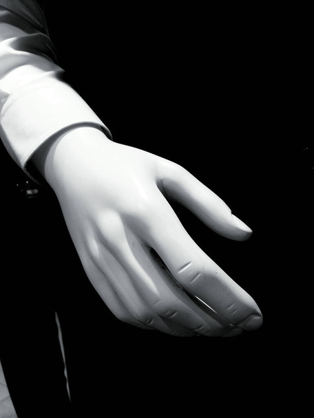 Close-up hand van etalagepoppen voor kleding in zwart-wit toon. Plastic deel van het lichaam. Valse hand. - Foto, afbeelding