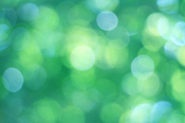 Abstract bokeh, natural green and blue background, beautifully blurred during the summer, which is a blue-green bokeh taken from the leaves on the tree and has a yellow-blue light - Фото, зображення
