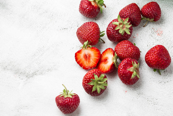 Fresh ripe perfect strawberry - Food Frame Background. Fresh strawberry as texture background. Natural food backdrop with red berries. Strawberries sale in a food market. - 写真・画像