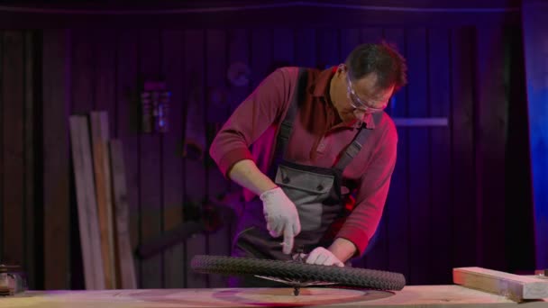 Mechanic repairing a bicycle wheel in a garage. - Footage, Video