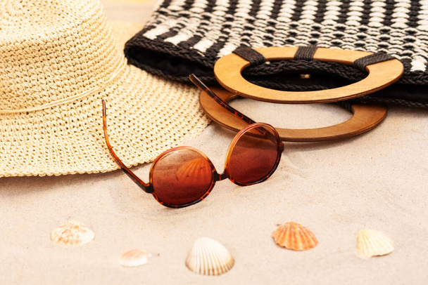 Vintage summer wicker straw beach bag, hat and sunglasses on the seashore of Catania, Sicily, Italy - Фото, изображение