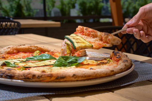 Delicious zucchini flower pizza, Italian Food on the terrace closeup - Foto, afbeelding