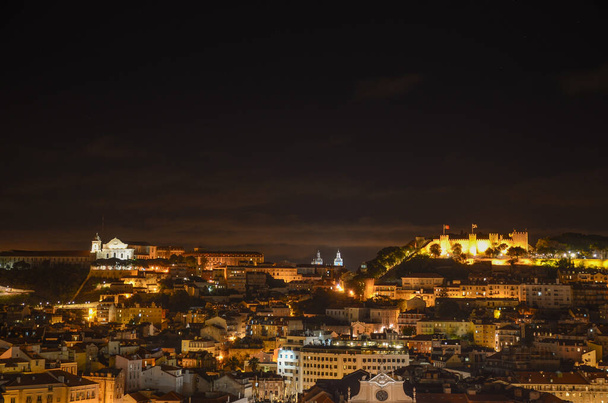 Night view of old town and Sao Jorge Castle from Sao Pedro de Alcantara viewpoint (miradouro), in Lisbon, Portugal - Photo, Image