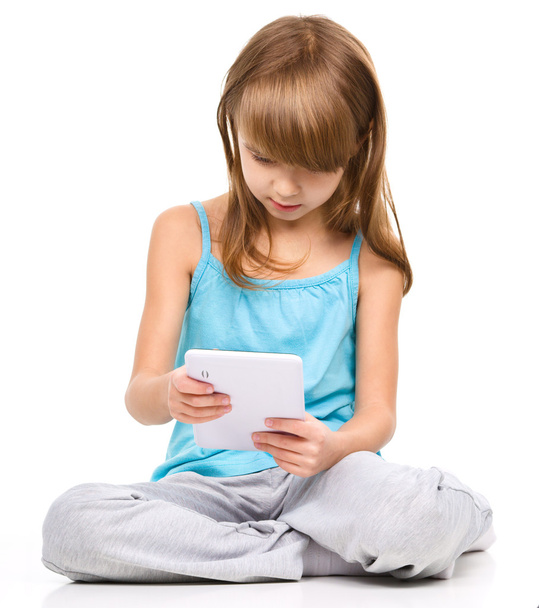 Young girl is using tablet - Foto, immagini