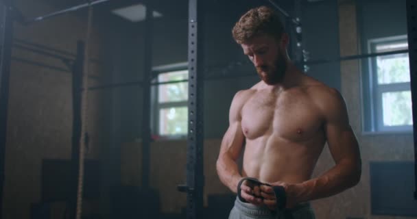 Young male athlete preparing himself for heavy lifting. Deadlift Weightlifting Wrist Straps Support For Bodybuilding And Powerlifting. the athlete trains in the gym, raises the bar - Footage, Video