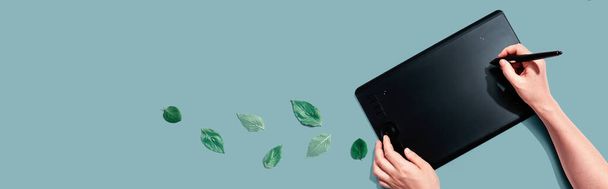 Graphic pen tablet with green leaves - Photo, Image