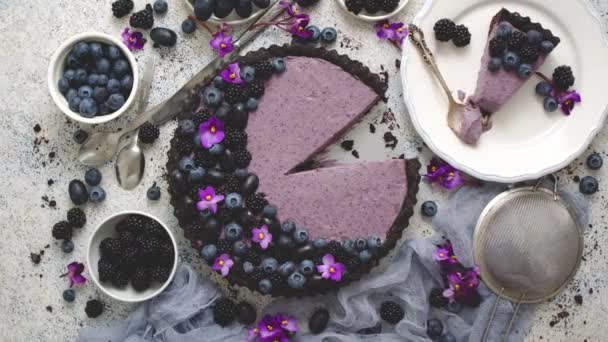 Plate with homemade piece of delicious blueberry, blackberry and grape pie or tart served on table - Video