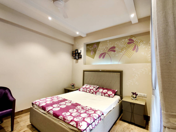 wide angle shot of a modern well designed bedroom with great lighting - Photo, Image