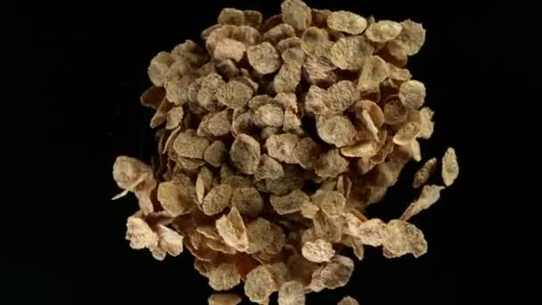 Super slow motion of rotating corn flakes on black background. Filmed on high speed cinema camera, 1000fps. - Materiał filmowy, wideo