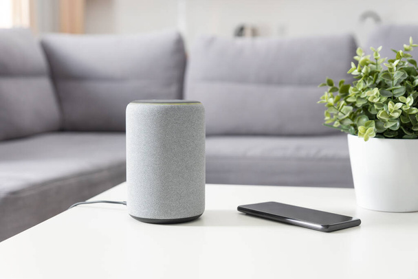Smart speaker device in living room. Intelligent assistant in smart home system. - Fotó, kép