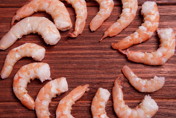 Premium raw shrimp. Fresh and raw shrimp on wooden table. - Photo, Image