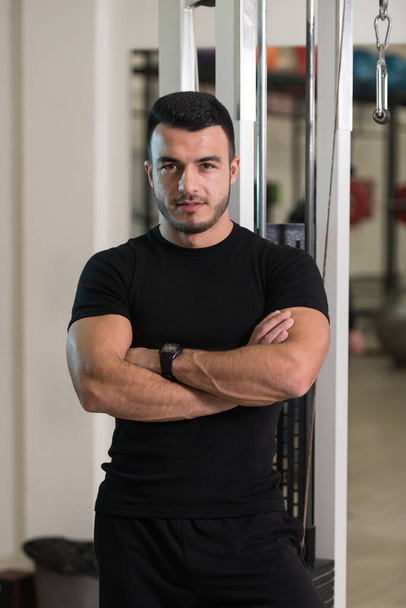 Portrait Of Handsome Personal Trainer Wearing Sportswear In Fitness Center Gym Standing Strong - Fotó, kép
