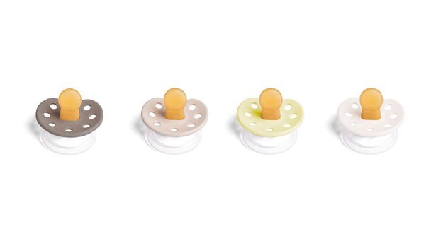 pacifiers in four different colors. concept that all human beings are equally important - Photo, Image