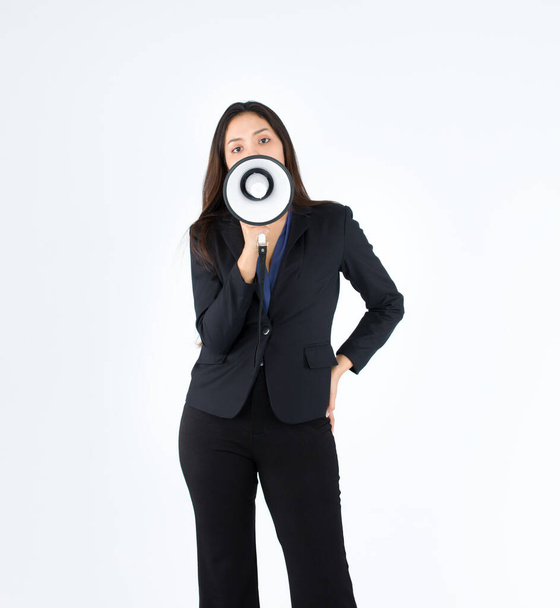 Pretty Asian Woman is wearing a black suit and shouting on the megaphone As if protesting in the workplace. - Photo, Image