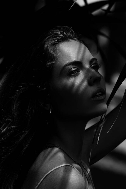 Black and white Portrait of a very beautiful sensual girl, on tropical background. Summer girl. Close-up. - Foto, Imagen