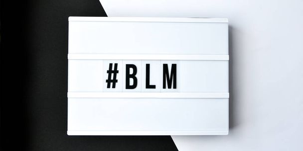  hashtag BLM BLACK LIVES MATTER text on a black and white background. Freedom of Speech Vintage Retro quote board. Protest against the end of racism, anti-racism, equality. Poster on violation of human rights - Photo, Image