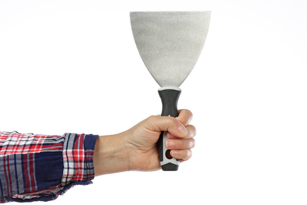DIY, hand and arm of a handyman with a checkered shirt holding a spatula on a white background, iillustration of the concept made by yourself or home made, DIY course - Photo, Image