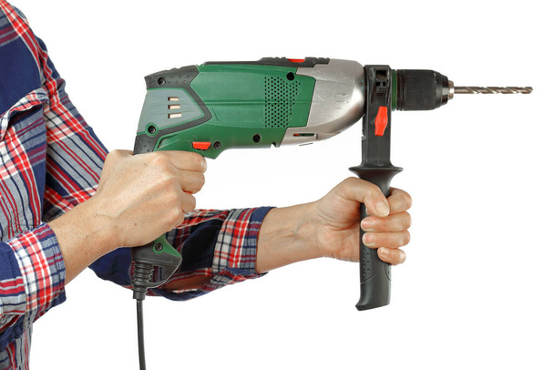 DIY, hand and arm of a handyman with a checkered shirt holding a drill on a white background, iillustration of the concept made by yourself or home made, DIY course - Photo, Image