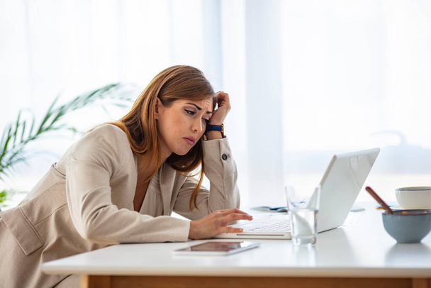 Fatigued businesswoman tired of computer work, exhausted employee suffering from blurry vision symptoms after long laptop use, overworked woman feels eye strain tension problem - Photo, image