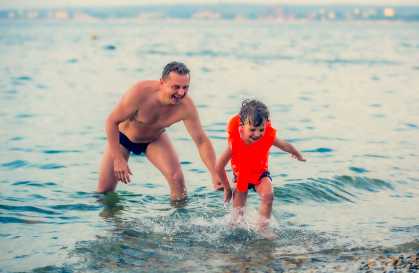 Father with son swimming in sea, travel, summer - Valokuva, kuva