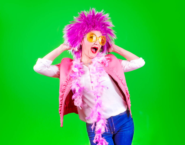 crazy woman dressed in creative carnival costumes on a colored background - Foto, Imagen