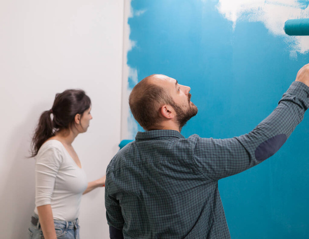 Husband painting the wall carefully - Photo, Image