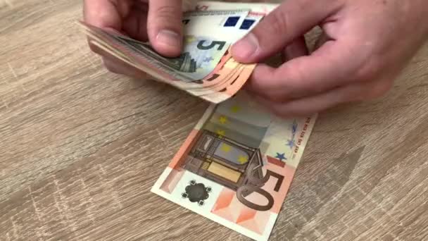 Close up of male hands counting large amounts of money by hand in cash. Counting banknotes of 50,10 and 5 euro. The concept of investment, success, financial prospects or career growth. 4K. - Footage, Video