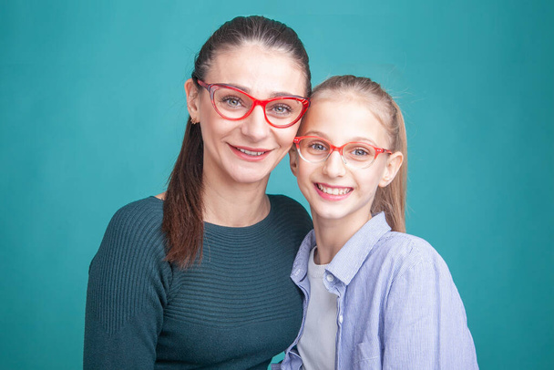 woman and girl teenager in glasses for vision in the studio - 写真・画像