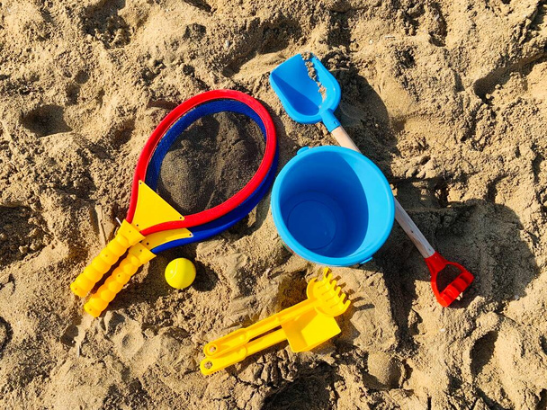 Vacation image of childrens beach toys on the sand - Фото, изображение