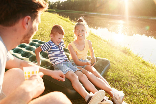                                Família passar o verão junto ao lago
 - Foto, Imagem