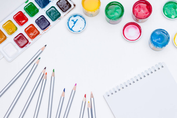 Notebook, paints, pencils on white background. Back to school. - Fotografie, Obrázek