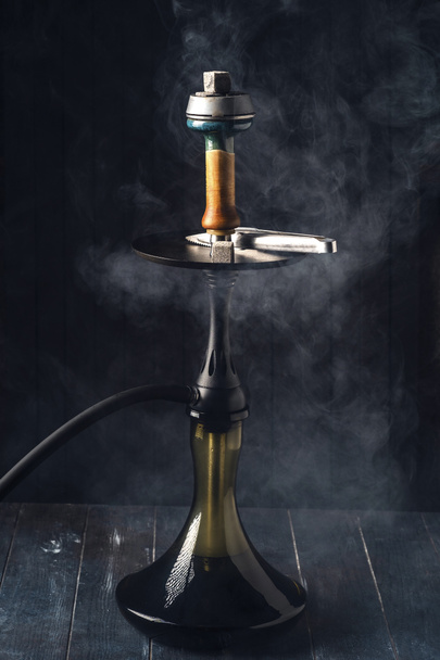 Hookah in smoke on dark wooden background - Foto, immagini