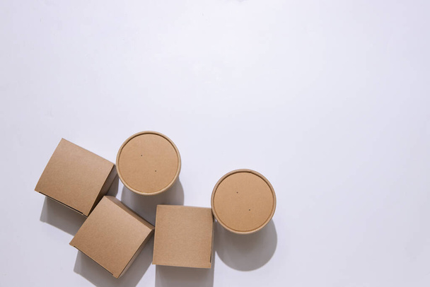 Cardboard containers and a bag for food, drinks and objects. White background. Isolate Top view. Copy space. Delivery concept, takeaway, craft packaging.   - Photo, image
